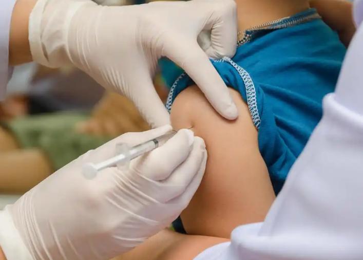 Doctor giving injection to arm